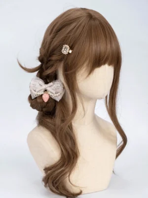 Gray pink Jirai Kei pearl chain bow hair clip on brown mannequin wig three-quarter view lace ribbon design strawberry charm details
