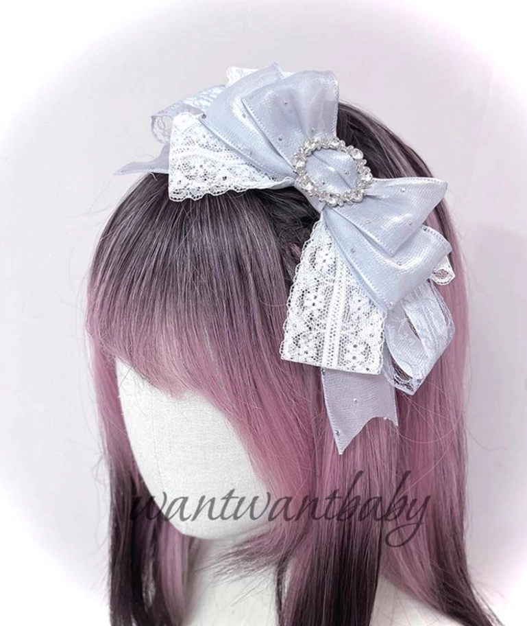 Gray and white shiny satin rhinestone bow jirai kei hair accessory with layered ribbons and rhinestone brooch on mannequin
