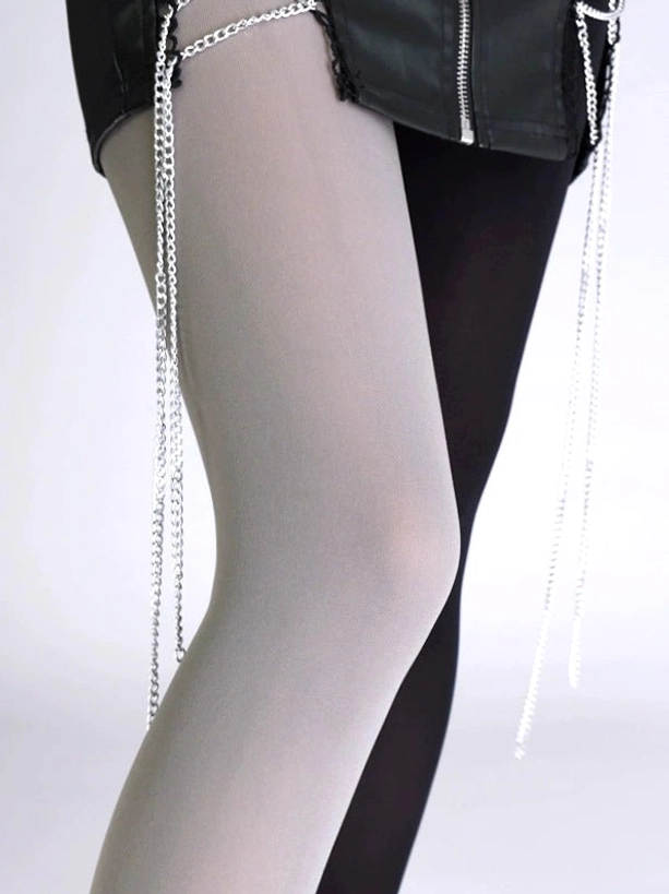Close-up side view of grey and black split velvet pantyhose with chain tassel decorative details