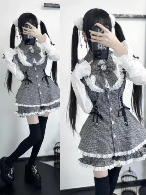 Grey plaid Jirai Kei lolita dress set with lace trim, bow necktie, and layered ruffled skirt worn with twin tails in dark indoor room full-body mirror view