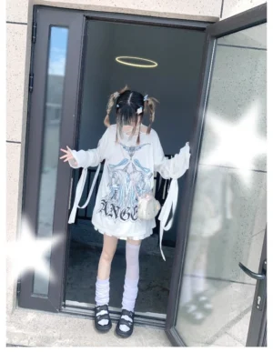 Long-sleeve halter neck graphic t-shirt full body front shot outdoor doorway worn with thigh-high socks and platform sandals showing adjustable sleeve straps