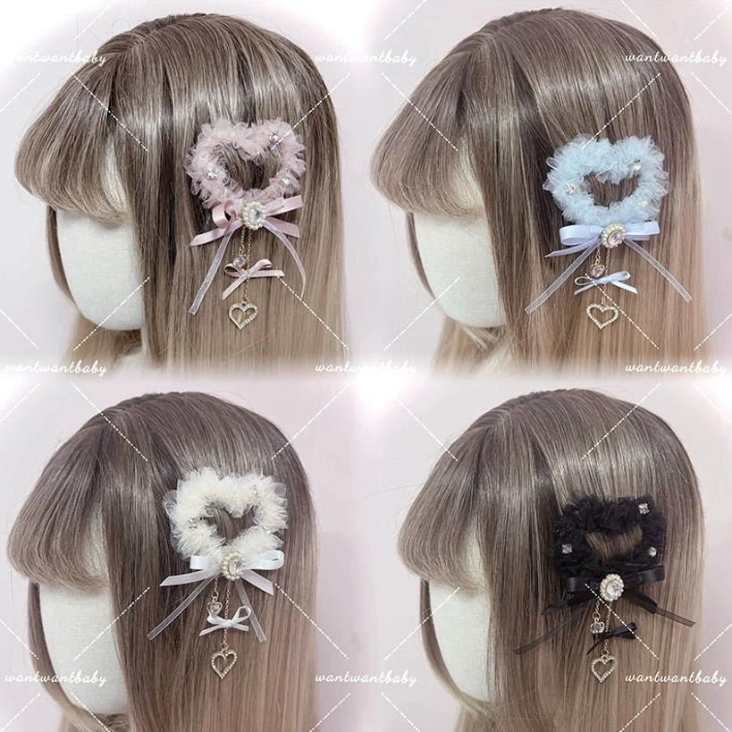 Mannequin heads wearing all four heart-shaped tulle hair clip colors: pink, light blue, ivory, and black in front view