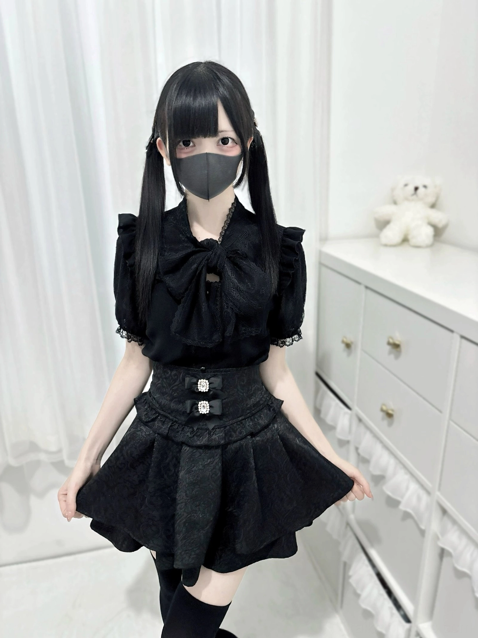 High-waist black Jirai Kei skirt three-quarter angle view decorative buckles ruffled layers jacquard weave