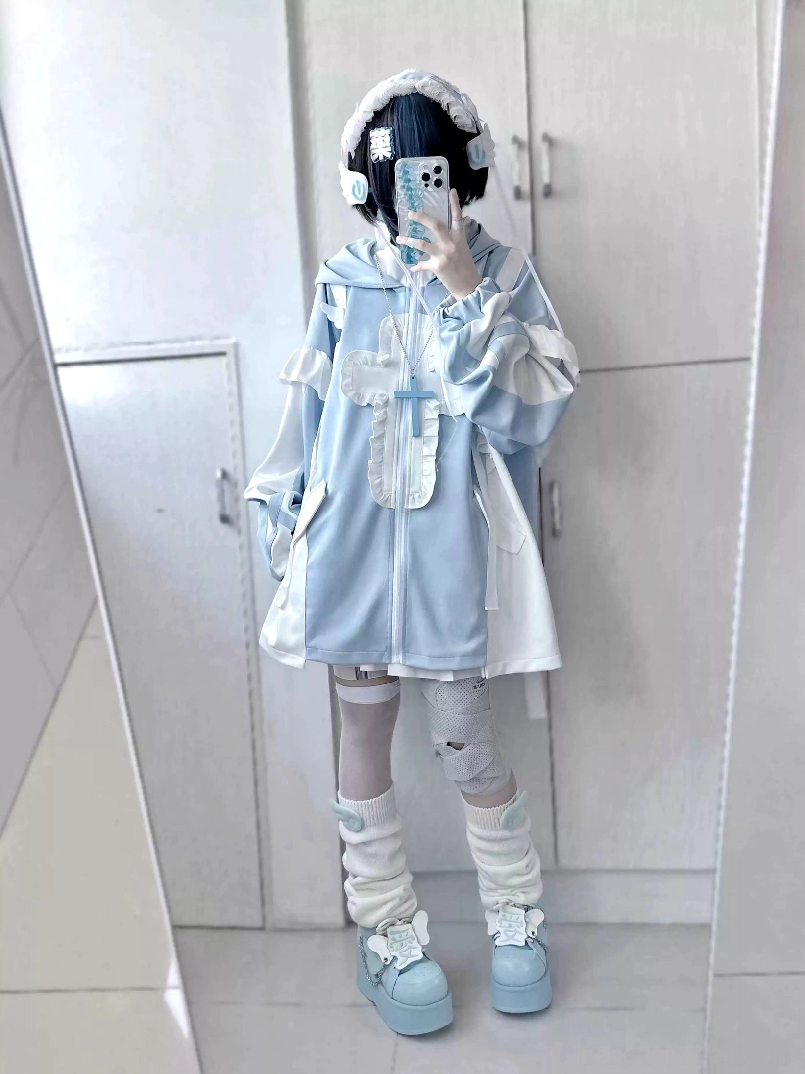 Front full-body hooded cat ear tenshi coat set in pastel blue, demonstrating flounce details, earmuff accessory, bandaged thigh-highs and light blue leg warmers