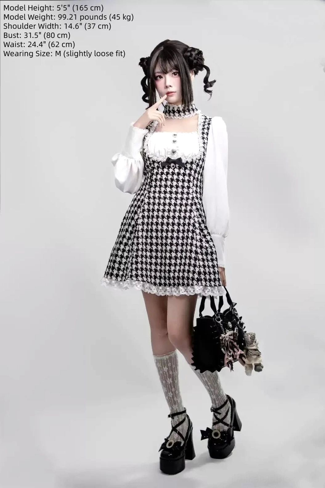 Full-body front view of houndstooth Jirai Kei maid dress with integrated choker, worn with ruffled socks and Mary Jane shoes, carrying vintage lolita handbag