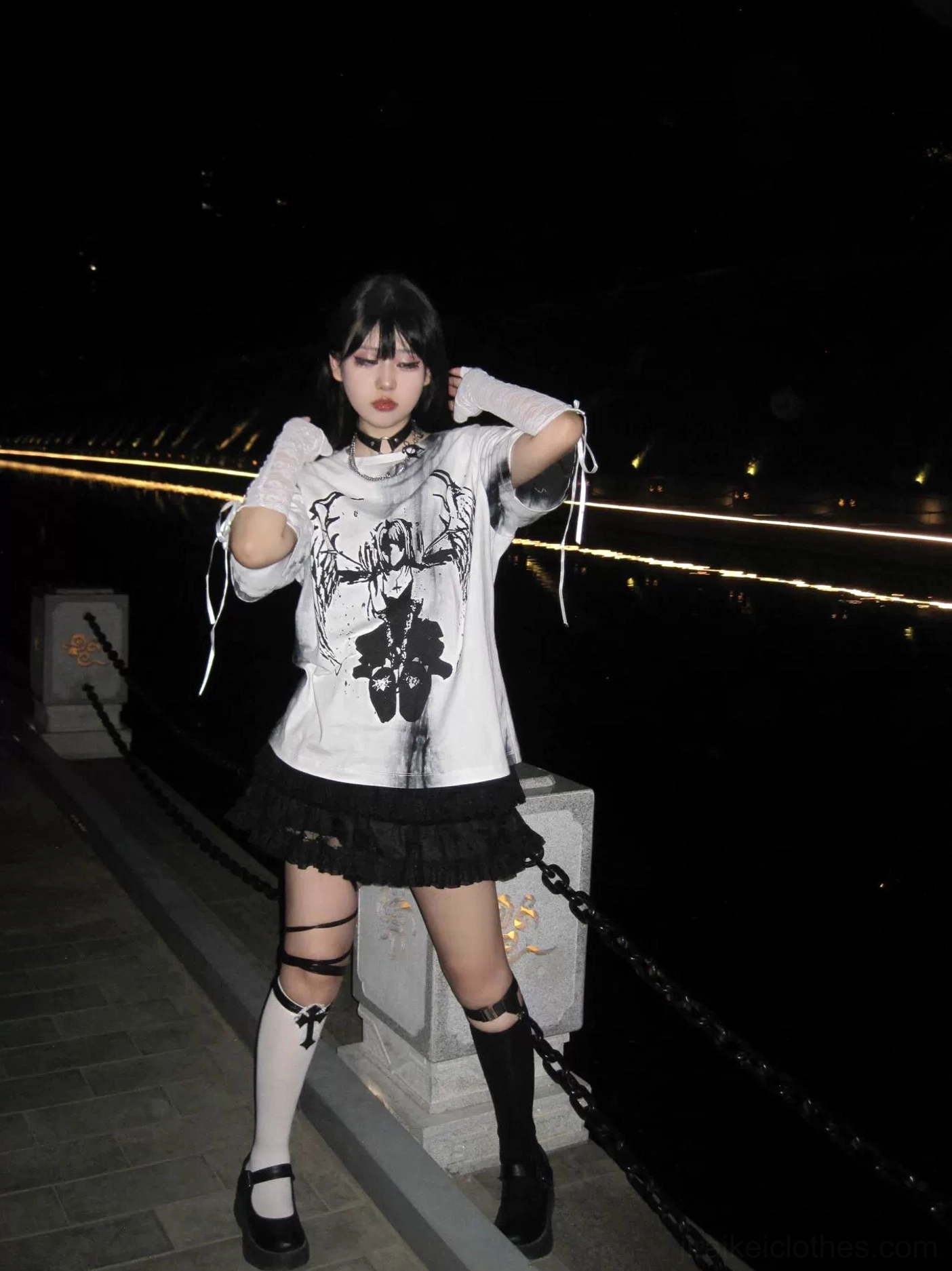 Side angle of unisex oversized tie-dye gothic jirai kei t-shirt with drawstring design, dark graphic print, night riverside setting