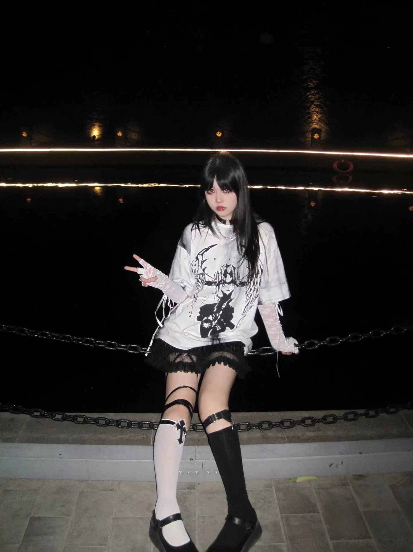 Front full-body shot of tie-dye gothic jirai kei t-shirt styled with white lace gloves, dark angel wings graphic, relaxed fit aesthetic