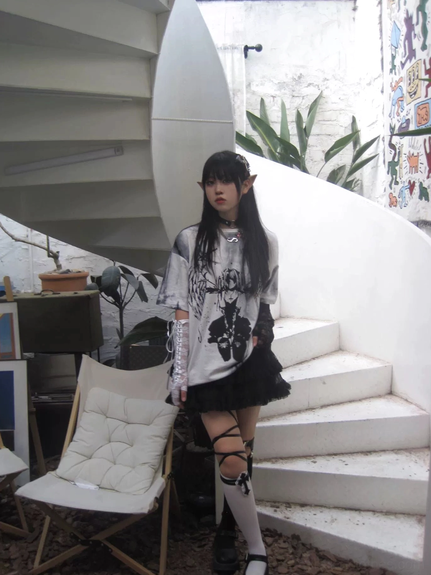Side view of oversized tie-dye gothic jirai kei angel t-shirt with strap thigh-high socks, ethereal dark graphic print outdoor styling