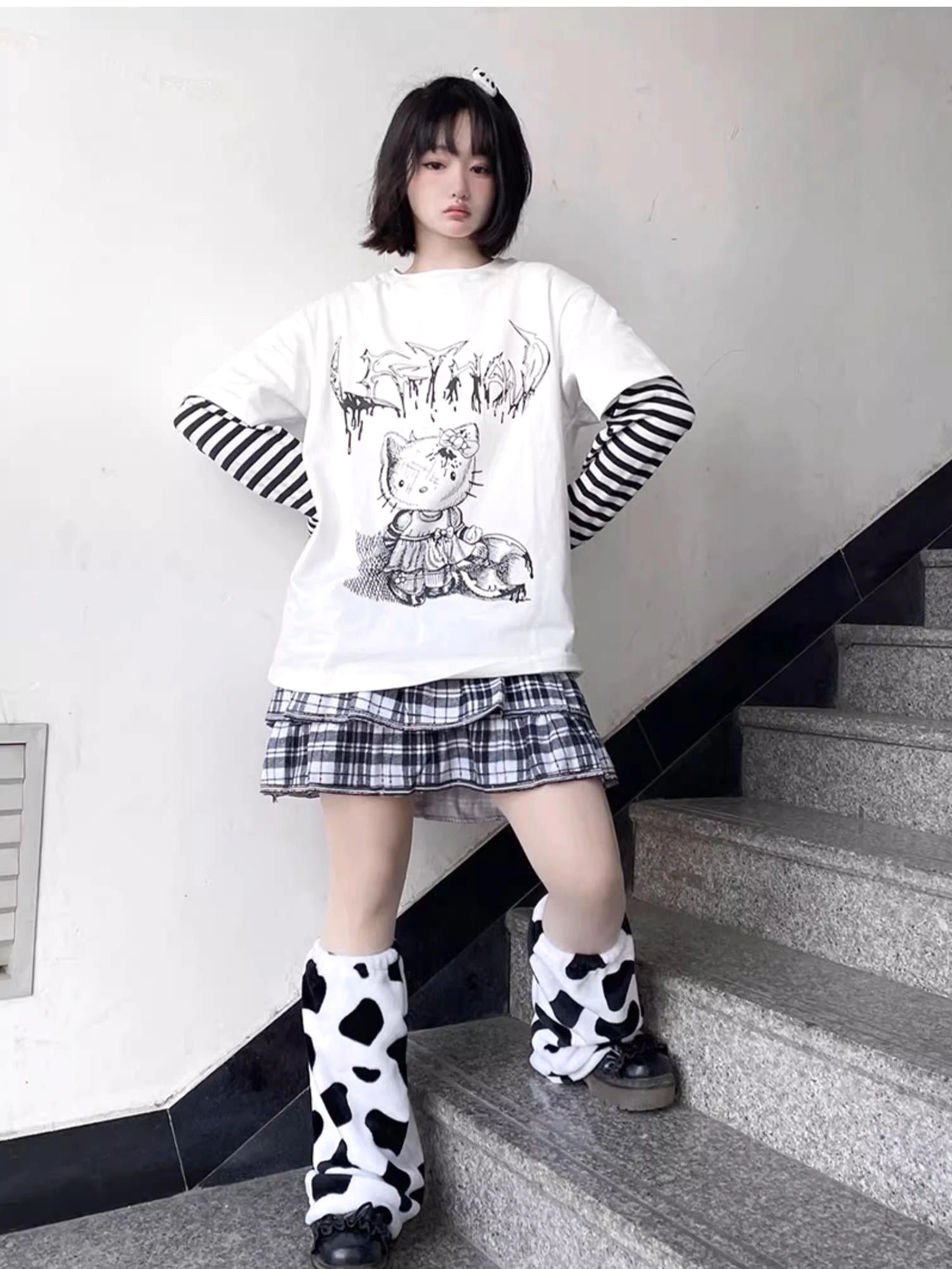 Front graphic print detail of jirai kei anime character design on false two-piece long sleeve striped punk tee