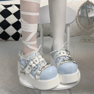 Jirai Kei baby blue glossy platform shoes with white thick sole and silver chain buckle accents worn with bandaged white stockings low-angle close-up foot shot