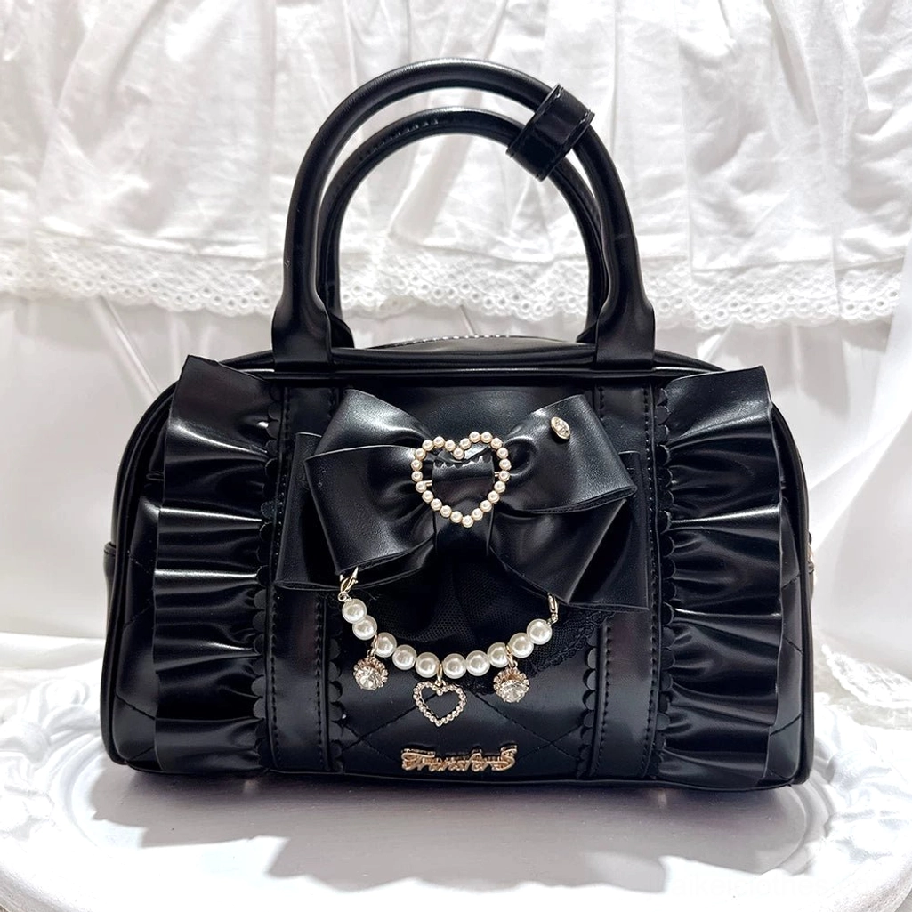 Classic black Jirai Kei handbag featuring quilted front panel, ruched sides, and heart pearl ornament bow decoration, overhead flat view