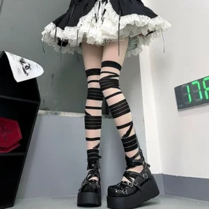 Black sheer thigh-high bandage socks with winding pattern styled with maid skirt and black platform shoes Jirai Kei aesthetic