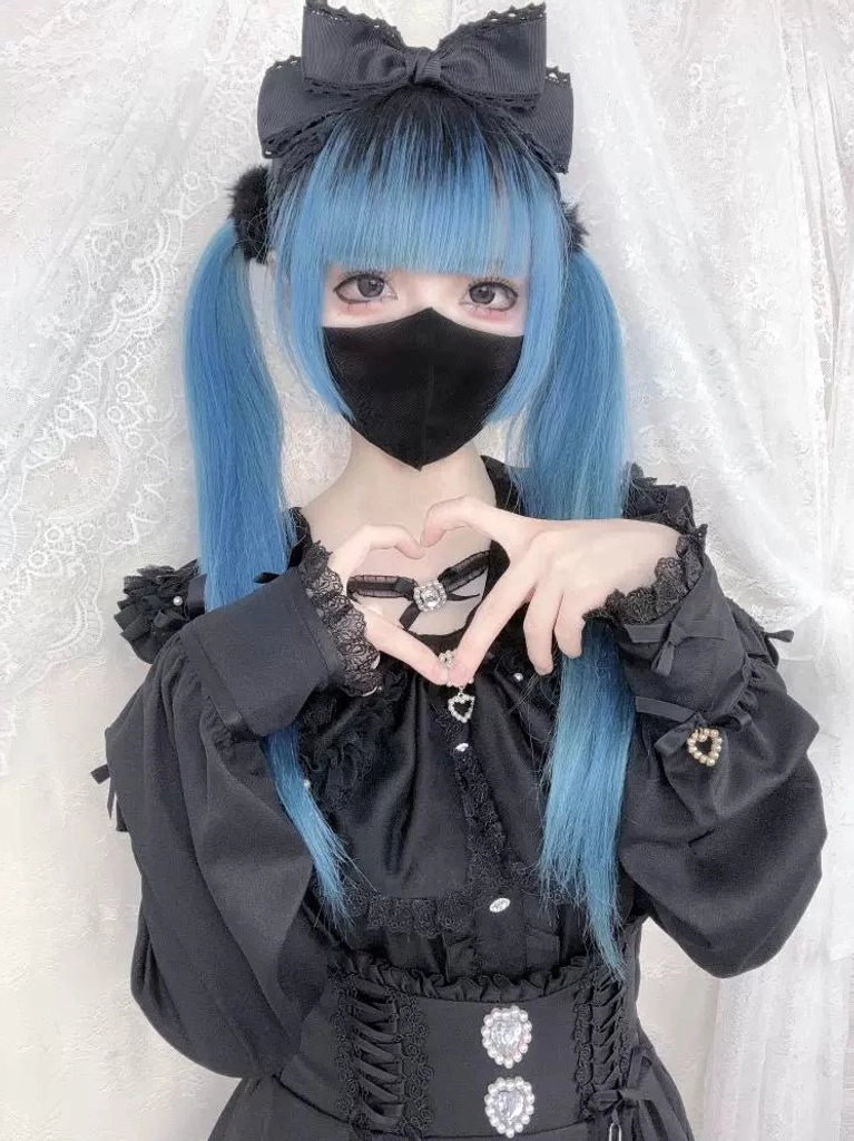 Black gothic Jirai Kei blouse with heart brooch and puff sleeves on model
