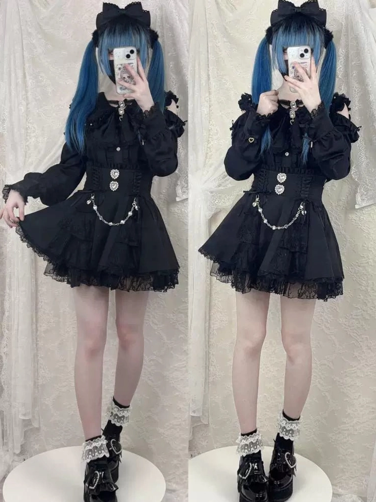 Mirror selfie of two models wearing black Jirai Kei mini dress with ruffled hem and waist chain