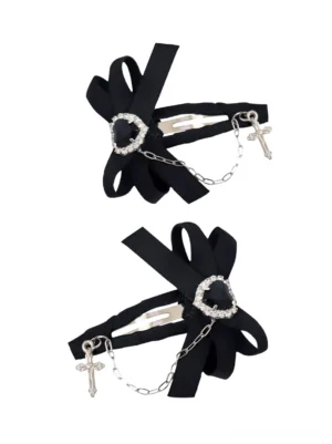 Black ryousangata Jirai Kei bow hair clip with heart gem and silver cross chain pendant snap clip mechanism oblique view