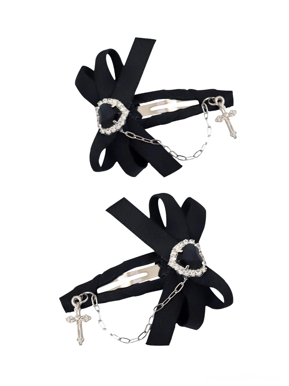 Black ryousangata Jirai Kei bow hair clip with heart gem and silver cross chain pendant snap clip mechanism oblique view