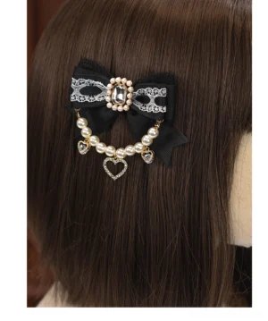 Black bow Lolita hair clip with pearl chain rhinestone heart pendant displayed on mannequin wig back view Jirai Kei aesthetic