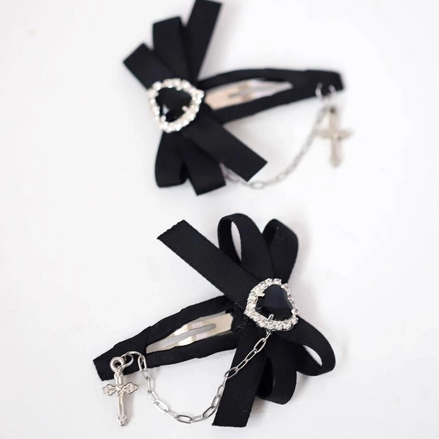 Pair of black Jirai Kei bow hair clips metal snap clip mechanism rhinestone decorative details white background