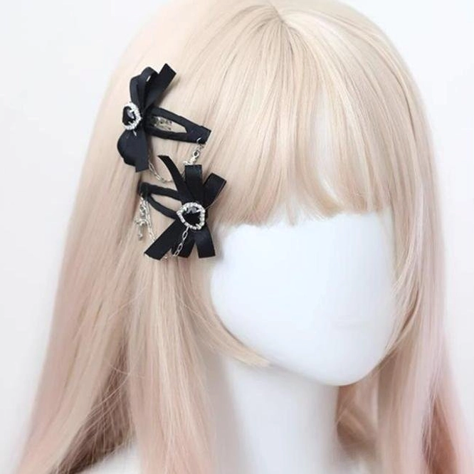 Black Jirai Kei bow hair clips worn on mannequin blonde bangs wig side head view styling demonstration