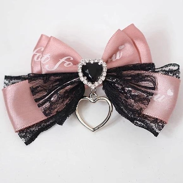 Black satin bow Jirai Kei hair clip with lace trim and purple heart-shaped crystal ornament, featuring hollow heart metal pendant detail, front flat lay