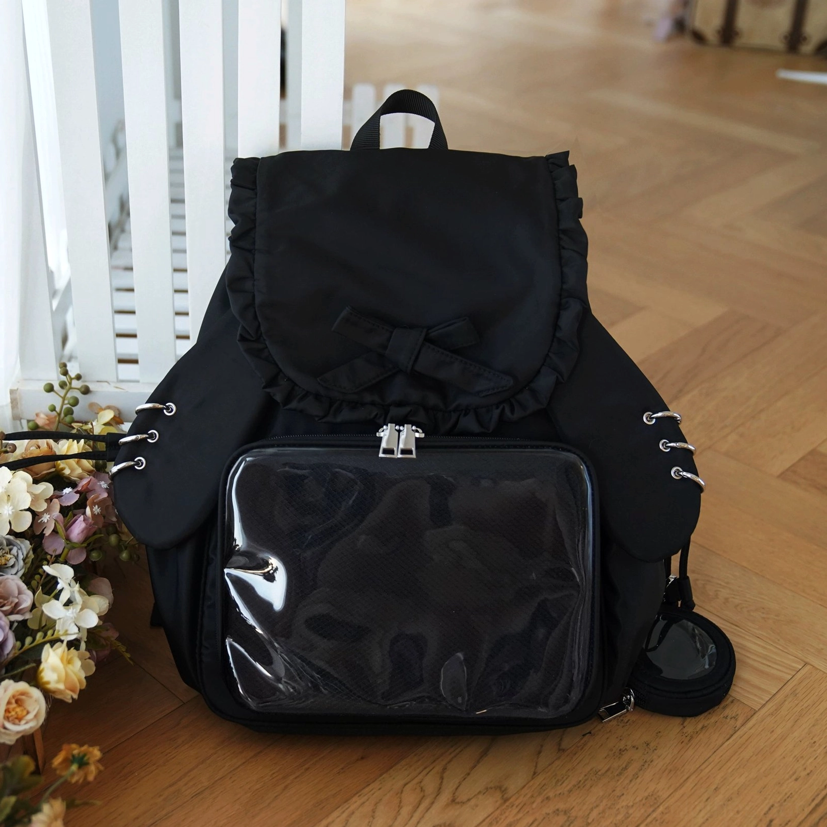 Black Jirai Kei kawaii itabag backpack with detachable bunny ears, clear acrylic display panel, and matching black mini coin purse pendant