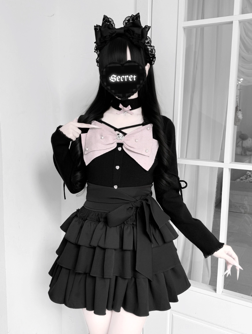 Black Jirai Kei coordinate on model three-quarter front view with fitted long-sleeve top ruffle tiered skirt cat ear hair accessory
