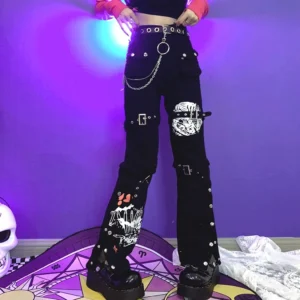 Black Jirai Kei flared cargo pants with side buckle straps, graphic prints, and decorative chain details worn by female model with hands on waist - full body front view