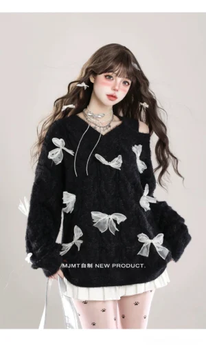 Black Jirai Kei fuzzy knit sweater with sheer white bows, cold-shoulder V-neck cut with drawstring detail, styled with pleated skirt and patterned tights, front-facing model view