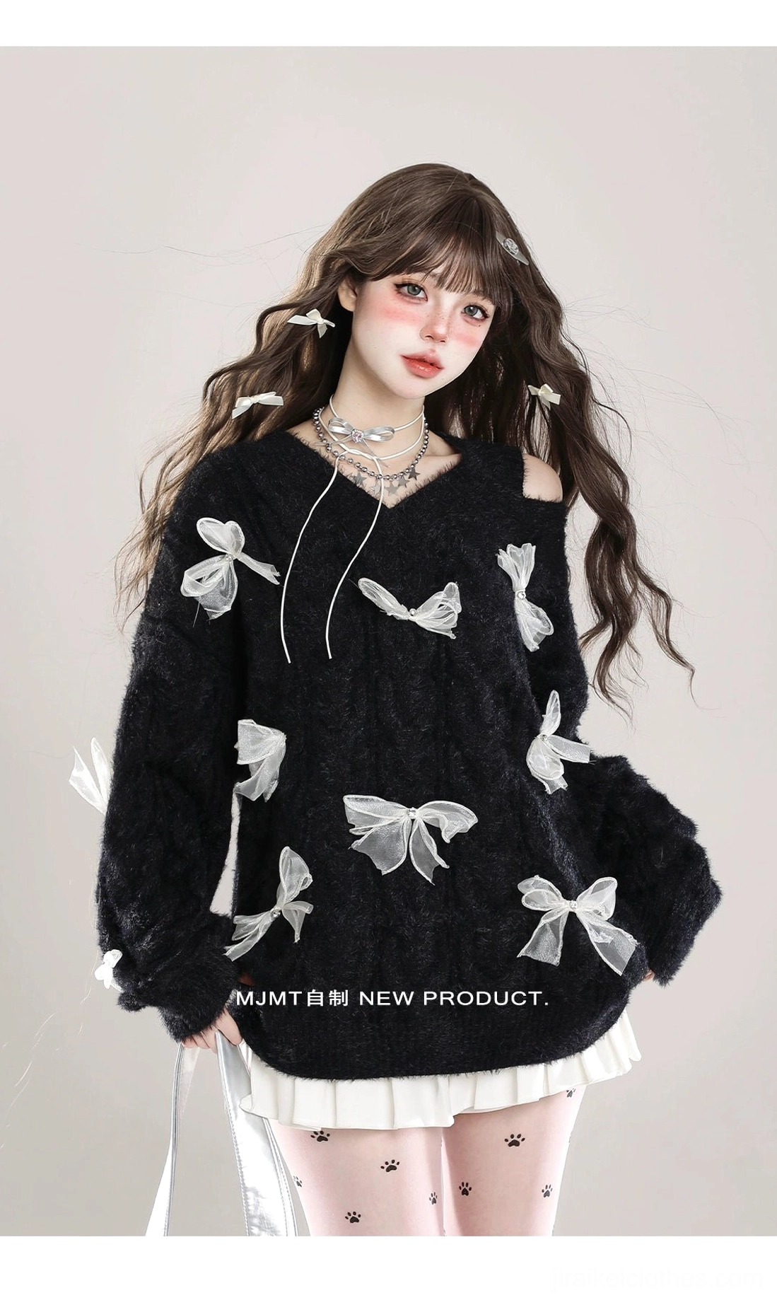 Black Jirai Kei fuzzy knit sweater with sheer white bows, cold-shoulder V-neck cut with drawstring detail, styled with pleated skirt and patterned tights, front-facing model view
