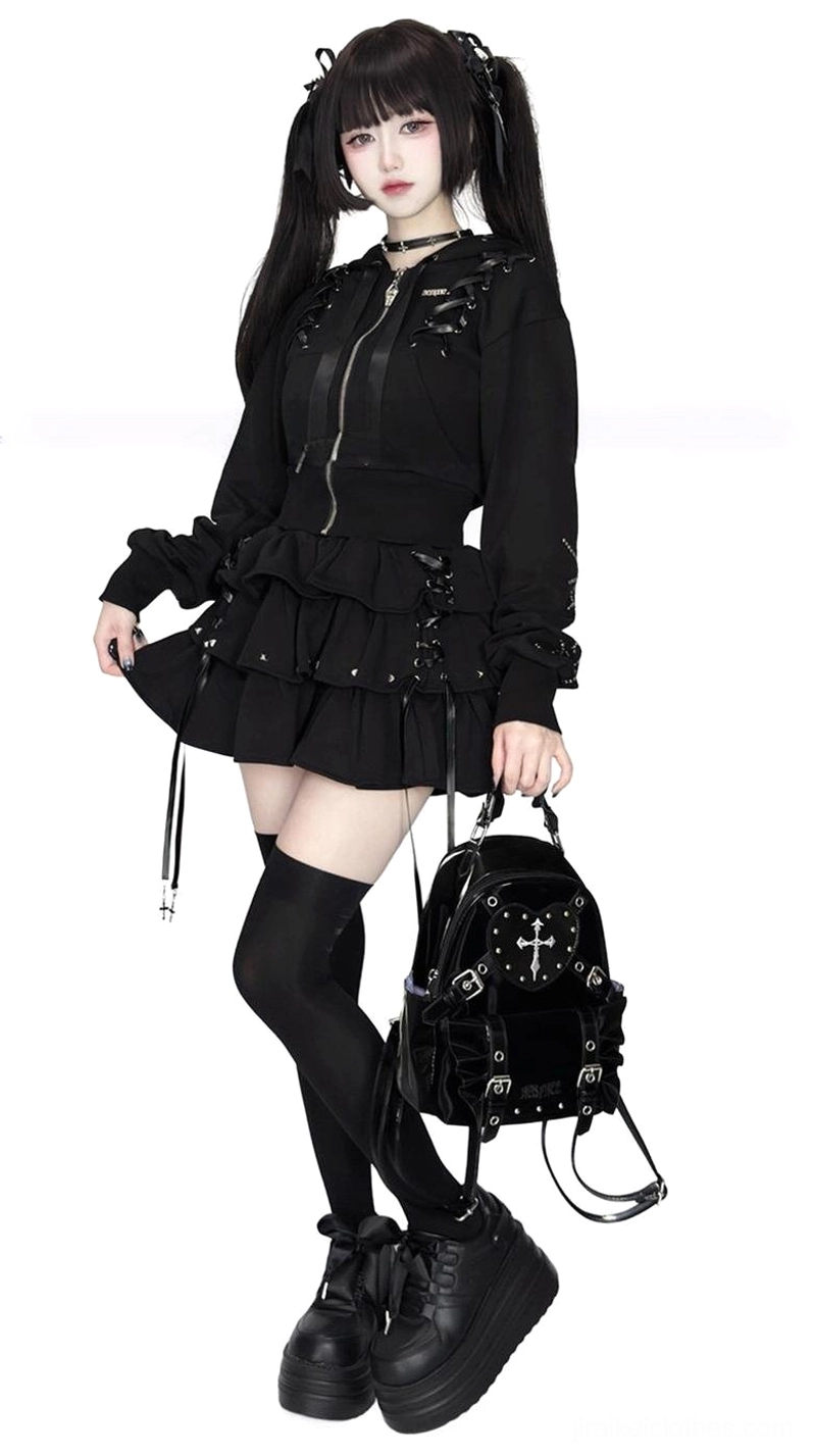 Black Jirai Kei gothic outfit with cropped hoodie ruffle skirt thigh-high socks and platform shoes side profile view with cross backpack