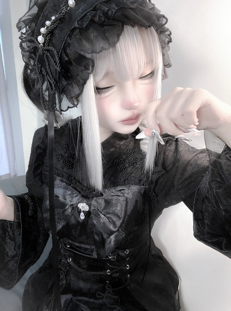 Black gothic lace ruffled hair bonnet with pearl decorations and long hanging ribbons, close-up model portrait in black gothic Lolita outfit, Jirai Kei hair accessory