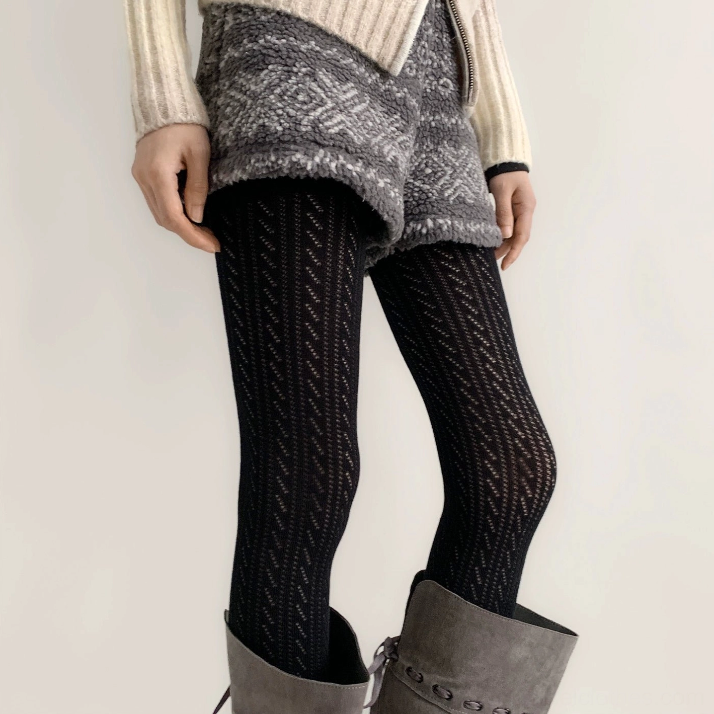 Black Jirai Kei hollow tights front view emphasizing leg-lengthening twisted vertical hollow pattern