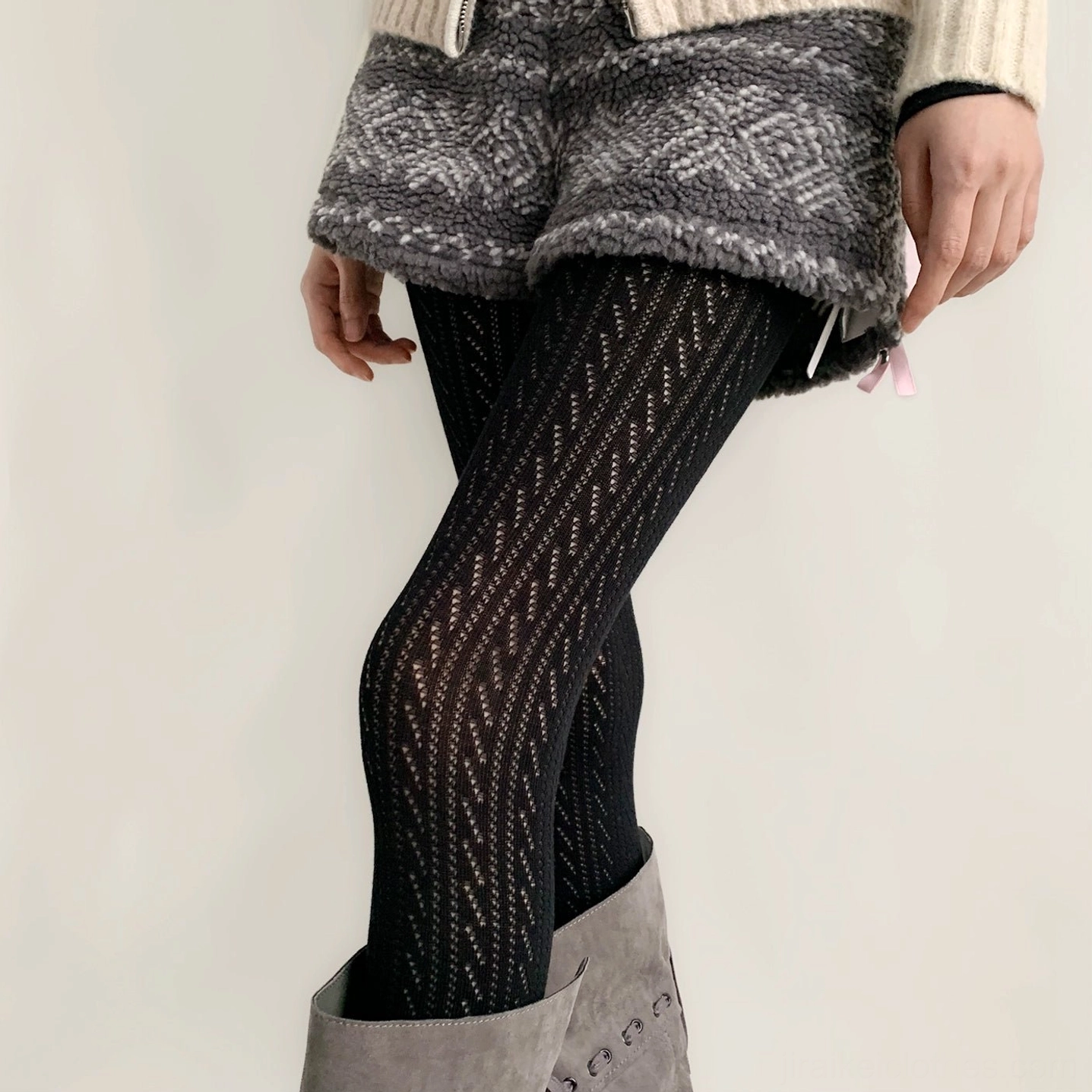 Black Jirai Kei hollow stripe tights side angle view showing fitted texture and twisted hollow design detail