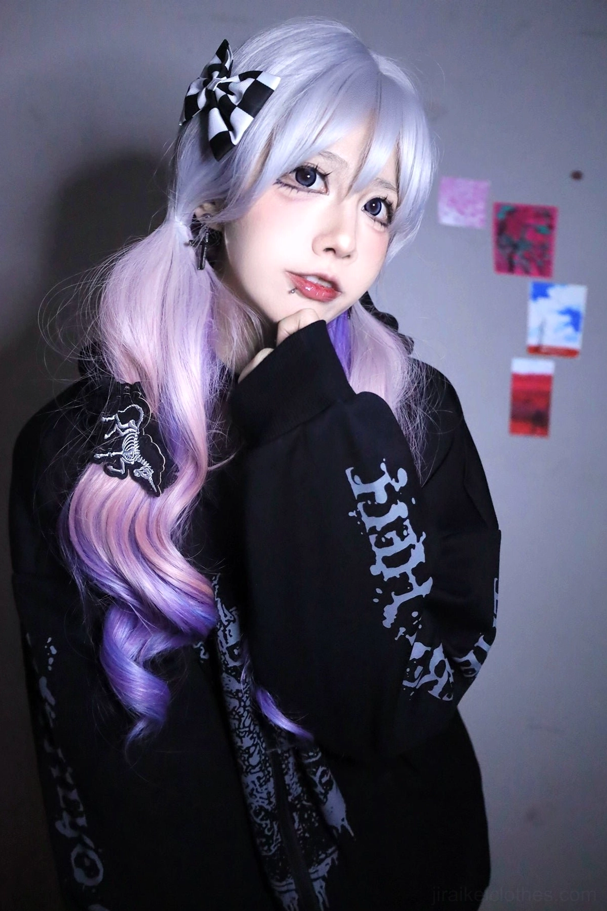 Black Jirai Kei hoodie on model with purple ombre hair and checkered clips, skeletal wing print visible, showing unisex fit and goth punk styling details