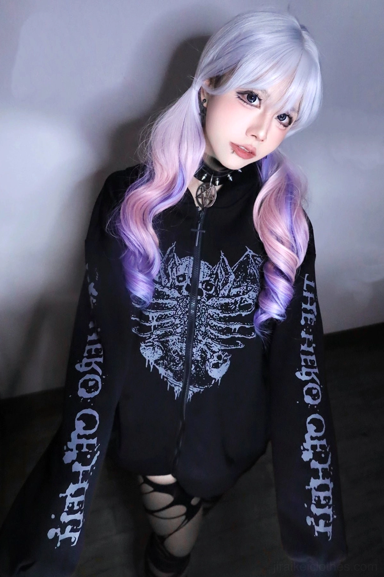 Black Jirai Kei gothic hoodie on model with purple ombre hair and choker, half-body portrait showing skeletal wing print design and goth punk styling