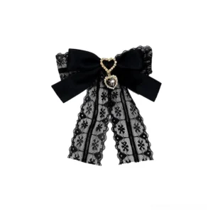 Black lace bow heart rhinestone hair clip featuring satin bow base with patterned lace tails and heart rhinestone decoration, displayed on clean white background for detailed Jirai Kei alternative fashion accessory view