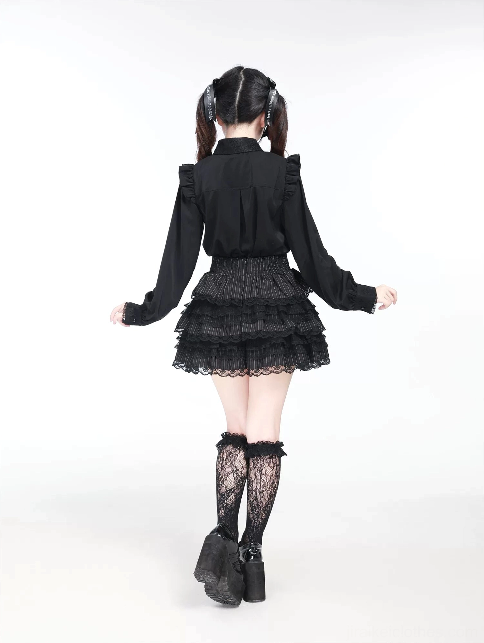 Black Jirai Kei blouse back view showing ruffled yoke design and long tailored sleeves on model wearing lace stockings
