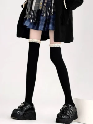 Jirai Kei lace knee socks black with white ruffled cuff worn with JK uniform plaid skirt platform loafers front low angle view