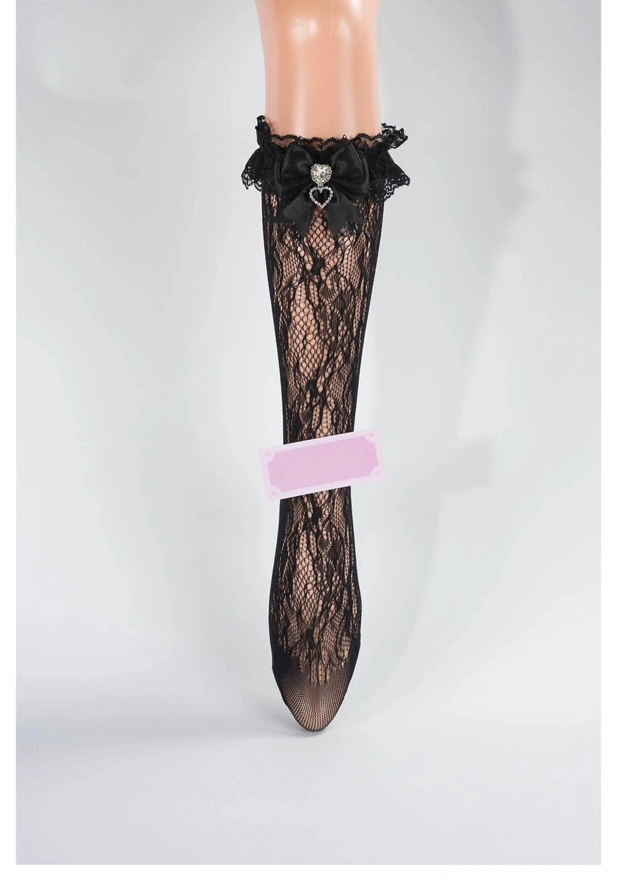 Black lace mid-calf Jirai Kei socks with ruffled black lace cuff, black bow and heart rhinestone embellishment, front full leg view