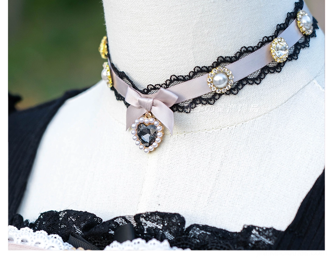 Black lace Jirai Kei choker necklace with black satin bow centerpiece heart rhinestone pendant and pearl accents