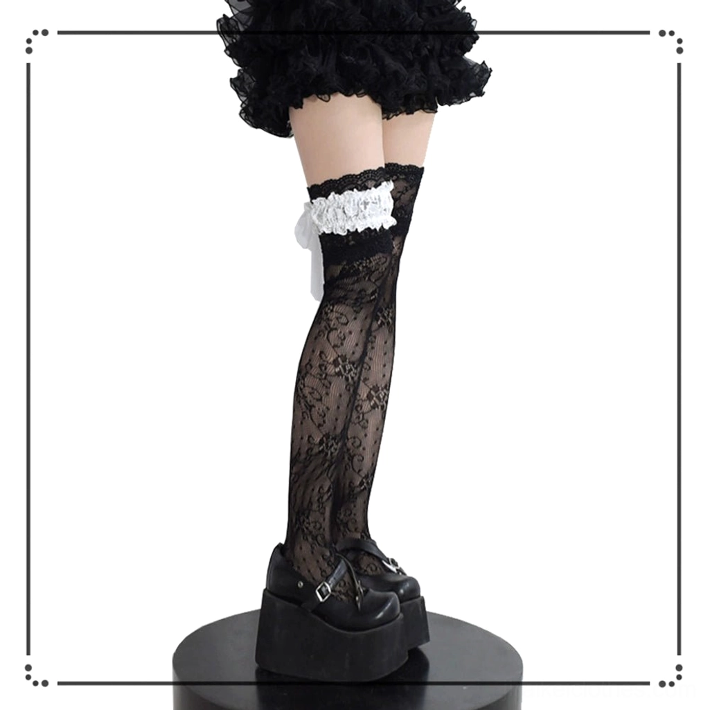 Single black lace thigh-high Jirai Kei stocking back side full leg view with white ruffled bow garter and platform shoes