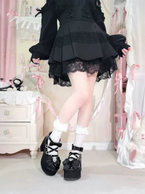 All-black lacquer Jirai Kei platform bow shoes with rhinestone heart bow worn with black lolita dress and frilly ankle socks