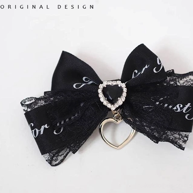 Black letter bow Jirai Kei hair clip with typographic ribbon elements and heart crystal charm, fashion-forward accessory for subculture styling
