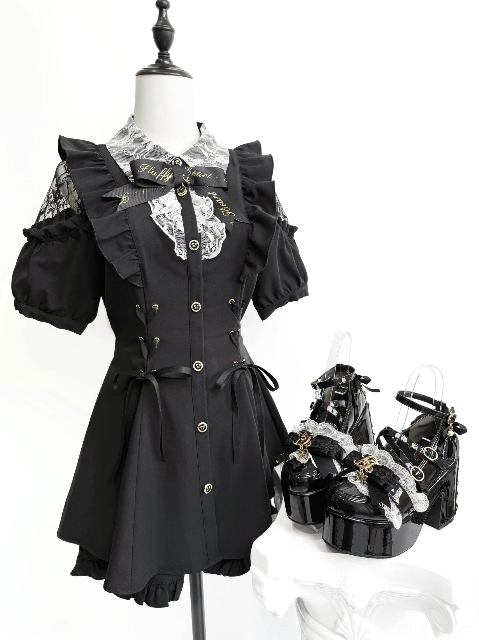 Full outfit flat lay featuring black Jirai Kei dress with ruffled lace collar puffed sleeves paired with matching black patent leather platform heels on mannequin display stand