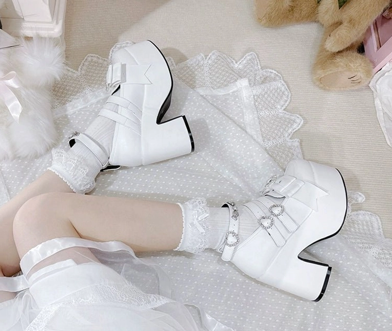 Black patent leather Jirai Kei platform heels featuring signature rhinestone embellishments and thick block heel construction detail