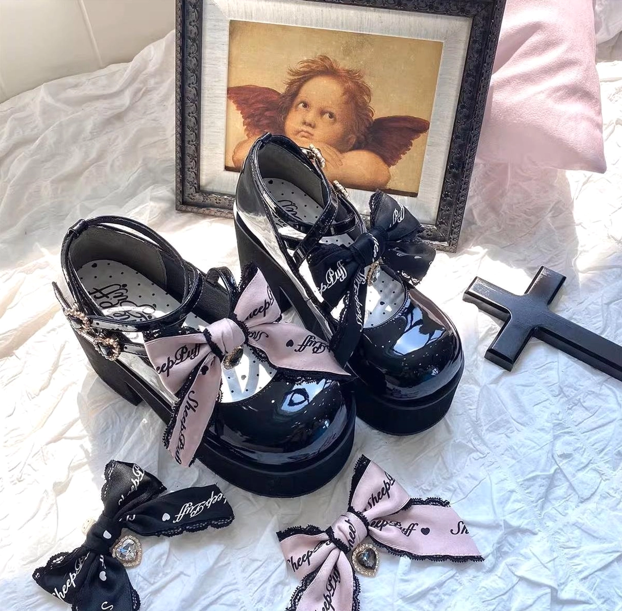 Black patent leather platform Mary Jane Jirai Kei shoes with three-point crisscross ankle straps, heart-shaped metal buckles, and chunky platform sole for confident styling