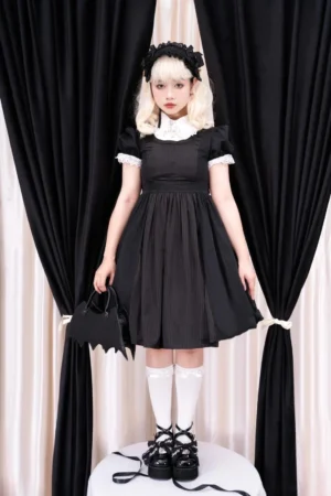 Black patent leather platform Mary Jane Jirai Kei shoes with crisscross buckle straps and bow decorations, worn by gothic lolita model in black dress