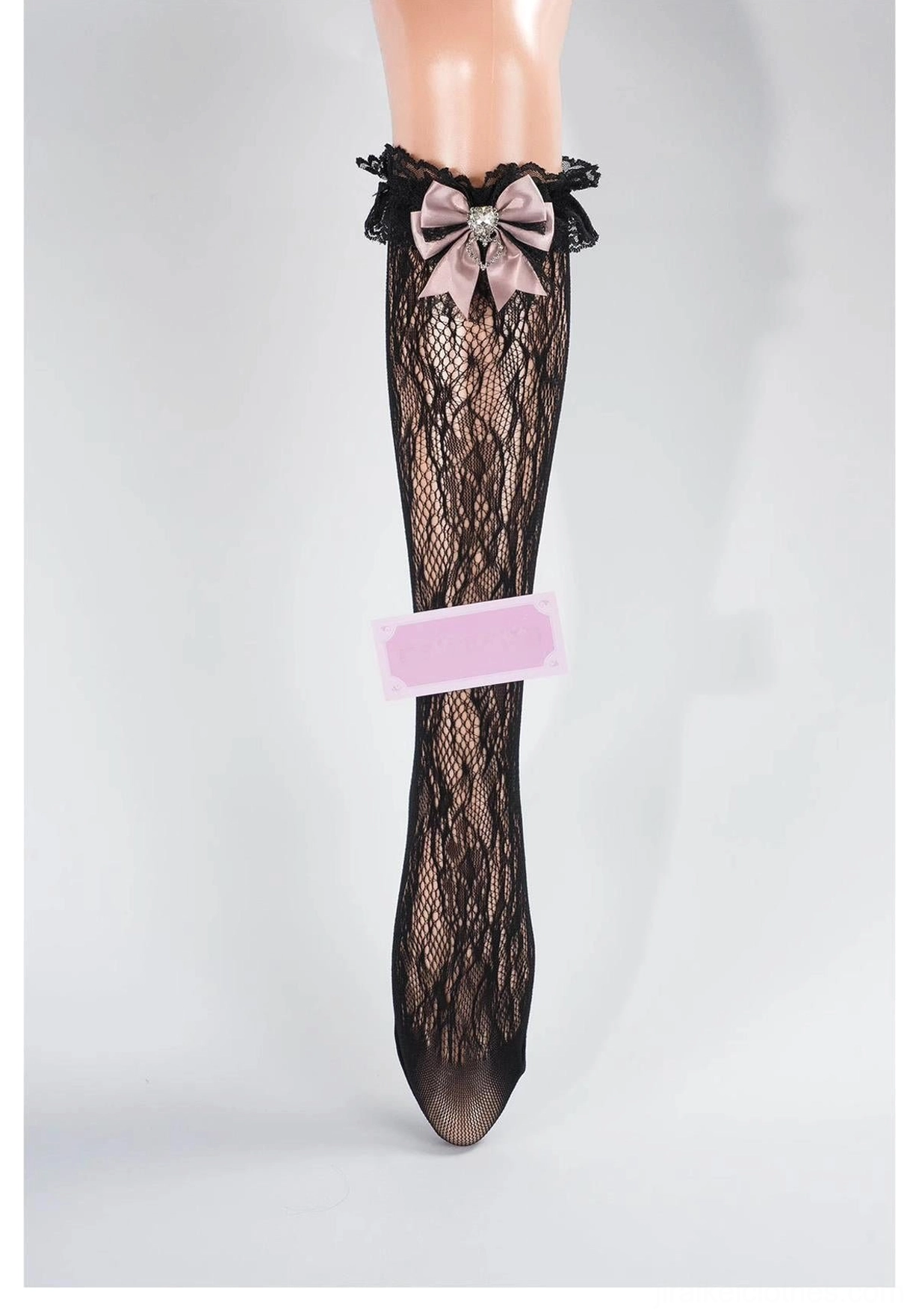Black lace mid-calf Jirai Kei socks with ruffled cuff, pink bow and heart rhinestone accent, black floral lace pattern, front view
