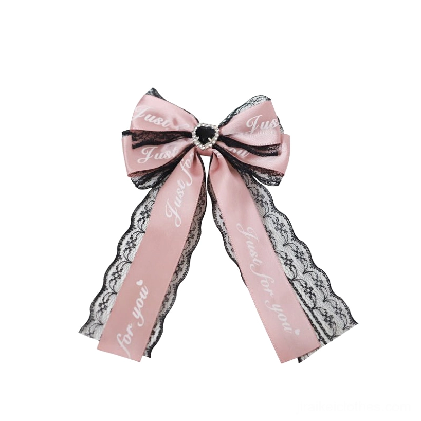 Black-pink long ribbon Jirai Kei hair clip with oversized satin bow, printed typography ribbon and heart crystal accent for twin-tail styling