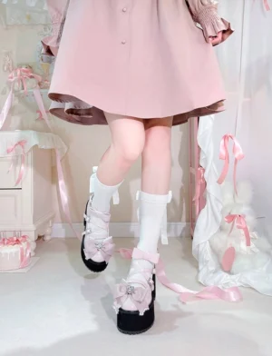Black and pink Jirai Kei platform bow shoes styled with pink skirt and frilly white socks in sweet lolita bedroom aesthetic